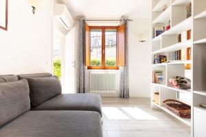 a living room with a couch and bookshelves at Fabio Apartments San Gimignano in San Gimignano