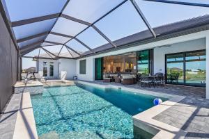 an indoor swimming pool with a glass ceiling at Gulf Access, Heated Saltwater Pool, Kayaks - Villa Sunset Lagoon in Matlacha