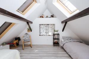 a attic bedroom with a bed and skylights at Serenity in Dramlje +56 photos