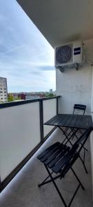 a balcony with a chair and a air conditioner at Apartmán Porte in Košice