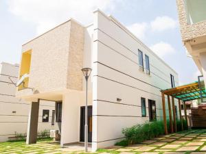 a white building with a street light in front of it at SERENE HAVEN RETREAT in Accra