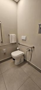a bathroom with a toilet and a towel rack at Rio Hotel by Bourbon São Paulo Barra Funda in Sao Paulo