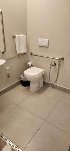 a bathroom with a toilet and a sink and towels at Rio Hotel by Bourbon São Paulo Barra Funda in Sao Paulo