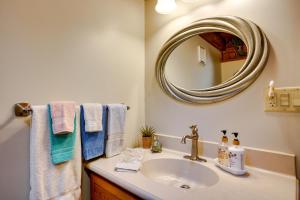 a bathroom with a sink and a mirror and towels at Peaceful Luray Cabin with Hot Tub, Deck and Fire Pit! in Luray +20 photos