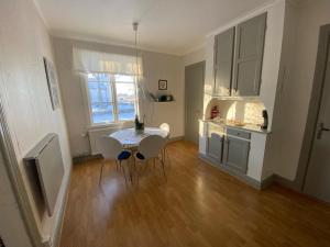 a kitchen with a table and chairs in a room at Ullenehus in Floby +9 photos