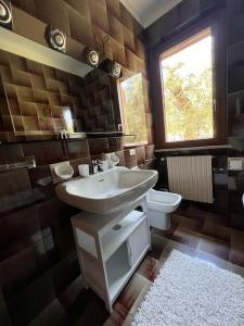 ein Bad mit einem Waschbecken und einem WC in der Unterkunft Casa Emy, tranquilla, ottima per Rilassarsi in Montinelle