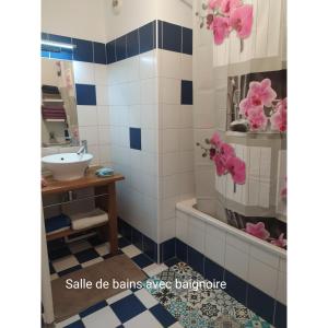 een badkamer met blauwe en witte tegels en een wastafel bij Appartement 3 chambres,îlot Pasteur-Auch in Auch