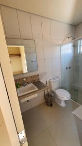 a bathroom with a toilet and a sink and a shower at Casa Bon Voyage - Guesthouse in Paraty