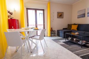 a living room with a table and a couch at Appartamento Nicoletta in Taormina
