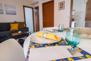 a table with a plate with a fork and a glass at Appartamento Nicoletta in Taormina