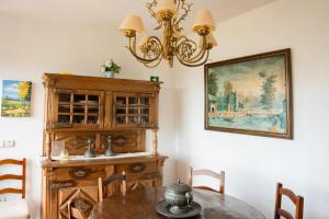 a dining room with a table and a chandelier at Cosy villa in Aveiro with shared pool and views in Aveiro