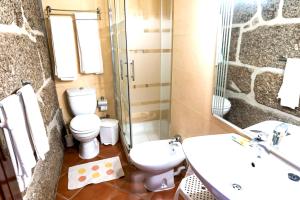 a bathroom with a toilet and a sink and a shower at Cosy villa in Aveiro with shared pool and views in Aveiro +24 photos