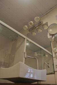 a bathroom with a sink and a mirror at Pousada Kico in Búzios