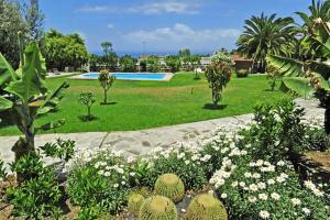 a garden with flowers and trees and a swimming pool at Ferienhaus für 10 Personen in Arucas, Gran Canaria Nordküste Gran Canaria in Arucas