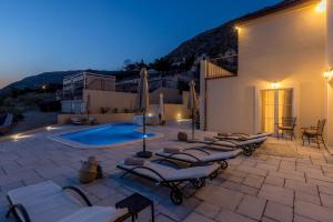 a patio with lounge chairs and a swimming pool at Ferienhaus für 8 Personen und 2 Kinder in Podstrana, Dalmatien Mitteldalmatien in Podstrana