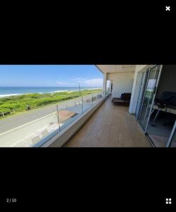 a room with a view of the ocean from a building at Beach House in Glenashley in Durban