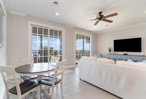 a living room with a white couch and a table at 311B - True Beachfront w/ Private Walkway and Pool in Myrtle Beach