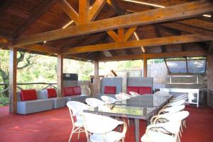 a patio with white chairs and a glass table and chairs at Villa La Ventana in Sant'Agnello