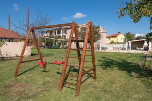 a wooden swing set in a yard at Ferienhaus mit Privatpool für 10 Personen ca 180 qm in Belavici, Istrien Bucht von Raša in Hreljići