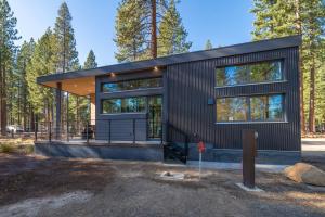 a modern house with a black siding at Village Camp in Truckee