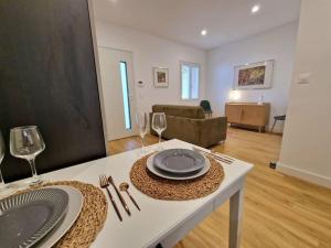 een woonkamer met een tafel met borden en wijnglazen bij BELAZUR Entre plage et port in Bandol