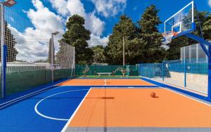 an orange and blue basketball court with a net at Ferienhaus mit Privatpool für 18 Personen ca 400 qm in Valtura, Istrien Südküste von Istrien in Pula