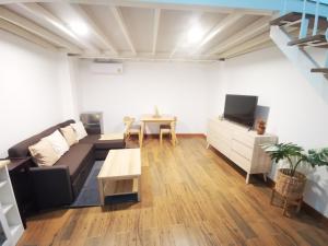 a living room with a couch and a table at Proud Room & wifi in North Pattaya