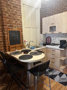 a kitchen with a table with chairs and a stove at Apartment in Great Location in Kadıkoy Seaside w. Amazing Shared Terrace in Istanbul