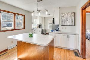 a kitchen with a island in the middle of a room at Pet-Friendly Sioux Falls House - 2 Mi to Downtown! in Sioux Falls