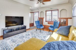 a living room with a tv and a couch and chairs at Pet-Friendly Sioux Falls House - 2 Mi to Downtown! in Sioux Falls