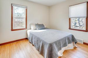 a bedroom with a bed in a room with two windows at Pet-Friendly Sioux Falls House - 2 Mi to Downtown! in Sioux Falls