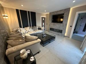 a living room with a couch and a fireplace at Riversdale House Next to Murrayfield Stadium in Edinburgh