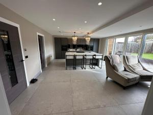 a living room with a couch and a kitchen at Riversdale House Next to Murrayfield Stadium in Edinburgh
