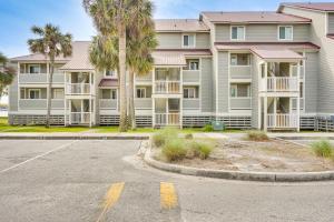 an empty street in front of a large apartment building at Folly Beach Retreat with Pool Access and River Views! in Folly Beach