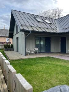 a house with a metal roof with a yard at Private Trakai Historical Centre Karaim Two Floor Apartment in Trakai