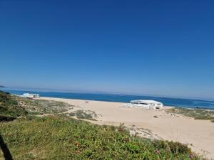 una spiaggia con due camper parcheggiati sulla sabbia di piccola a Valledoria