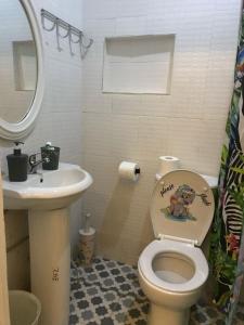 a bathroom with a toilet and a sink at Kujabi Holiday Home in Lamin