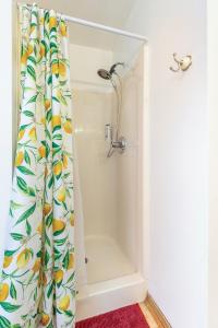 a bathroom with a shower with a shower curtain at Cozy 3BR Indy Home: Pets, Parking, Family-Ready in Indianapolis