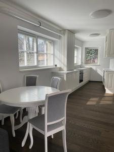 a kitchen with a table and chairs in a room at Private Trakai Historical Centre Karaim Two Floor Apartment in Trakai