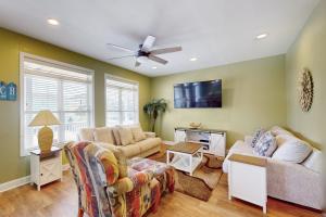 a living room with two couches and a ceiling fan at Escape to Ocean Isle in Ocean Isle Beach