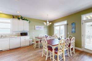 a kitchen and dining room with a table and chairs at Escape to Ocean Isle in Ocean Isle Beach