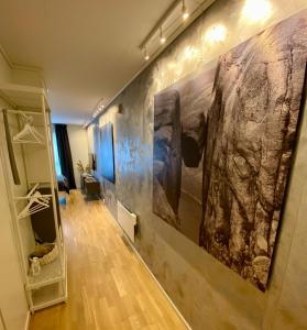 a hallway with a large painting on the wall at Experience a Cozy Getaway Near Pulpit Rock in Strand