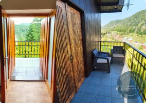 a room with a balcony with a view of a mountain at Chata MIMONKA in Dedinky