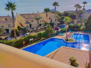 a view of a swimming pool from the balcony of a house at La Manga Club Resort - 3 bedroom Duplex - La Colina in Atamaría