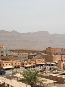 a town in the desert with mountains in the background at Dar Ilyana in Tamezmoute