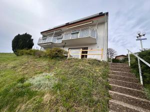 a building on top of a hill with stairs at Apart am Listersee in Meinerzhagen