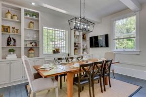 a dining room with a wooden table and chairs at Matchpoint House Aiken in Aiken