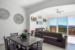 a living room with a table and a couch at Casa Granito 20 - Playa Arcangel in Rosarito