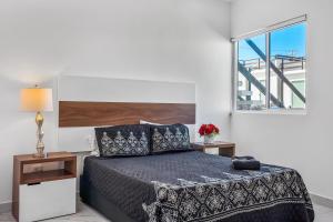 a bedroom with a bed and a window at Casa Granito 20 - Playa Arcangel in Rosarito +35 photos