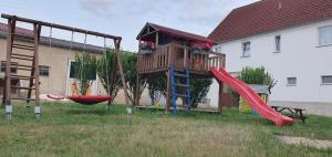 a playground with a tree house and a slide at Honighof Vierk in Langenleuba-Niederhain
